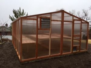 DIY greenhouse kit made with California redwood and premium polycarbonate paneling.