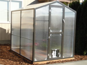 Affordable greenhouse kit with polycarbonate paneling and aluminum frame.