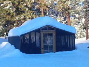 One of our redwood backyard greenhouse kits in the snow.