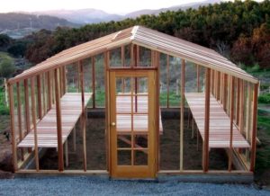 Beautiful redwood greenhouse kit overlooking valley and mountains.