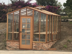 redwood greenhouse with brick base