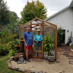 people in front of greenhouse