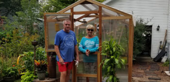 people in front of greenhouse